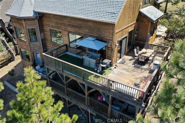 1305 Montreal Dr, Lake Arrowhead, CA 92352 - rear view of house featuring a hot tub, a deck, a shingled roof, and outdoor dining space