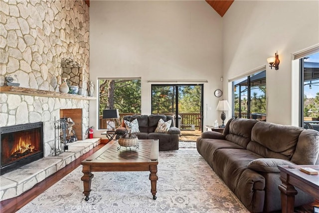 1305 Montreal Dr, Lake Arrowhead, CA 92352 - living area featuring high vaulted ceiling, a fireplace, and wood finished floors