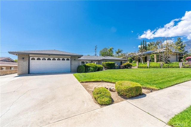 ranch-style home featuring an attached garage, driveway, brick siding, and a front yard