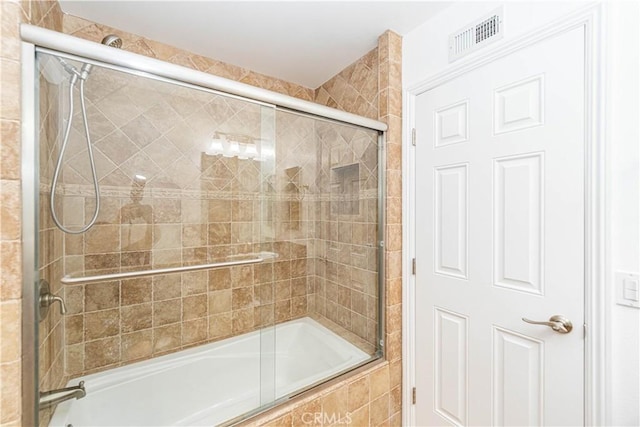 full bathroom featuring tiled shower / bath combo and visible vents
