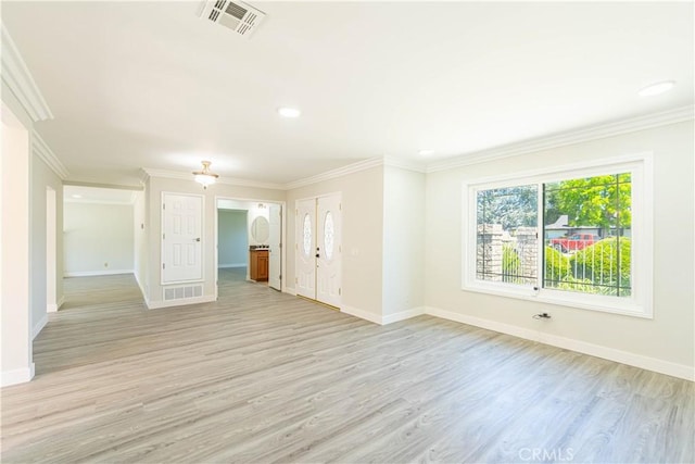 unfurnished living room featuring crown molding, baseboards, visible vents, and light wood-type flooring