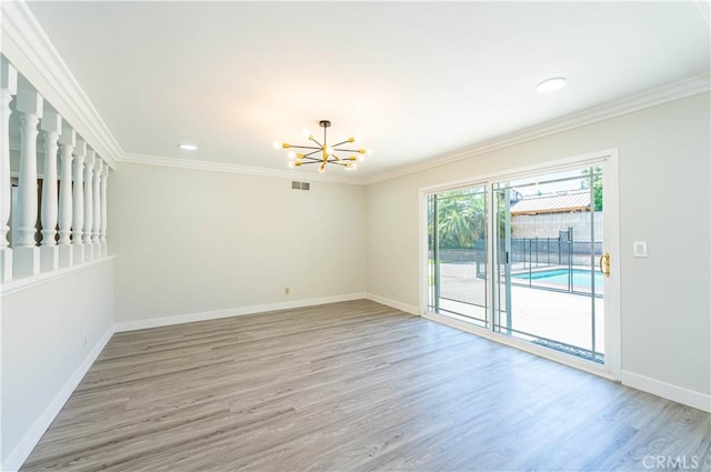 unfurnished room with crown molding, baseboards, a chandelier, and light wood-style floors