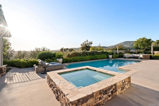 view of pool with a fenced in pool, an in ground hot tub, a mountain view, and a patio area
