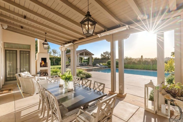 view of patio featuring outdoor dining area, a gazebo, a pool with connected hot tub, and a fireplace