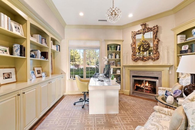 office space featuring ornamental molding, a fireplace, recessed lighting, built in shelves, and a notable chandelier
