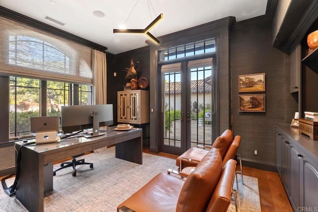office with french doors, visible vents, ornamental molding, and a healthy amount of sunlight