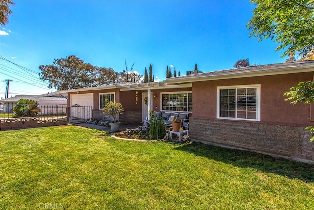 back of house featuring an attached garage, stucco siding, a yard, and fence