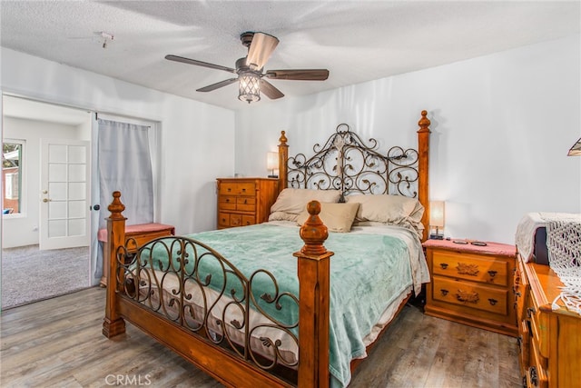 bedroom with a ceiling fan and wood finished floors