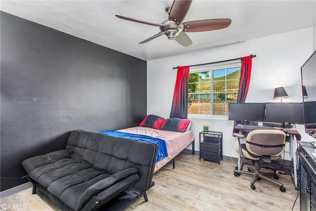 bedroom with ceiling fan and wood finished floors