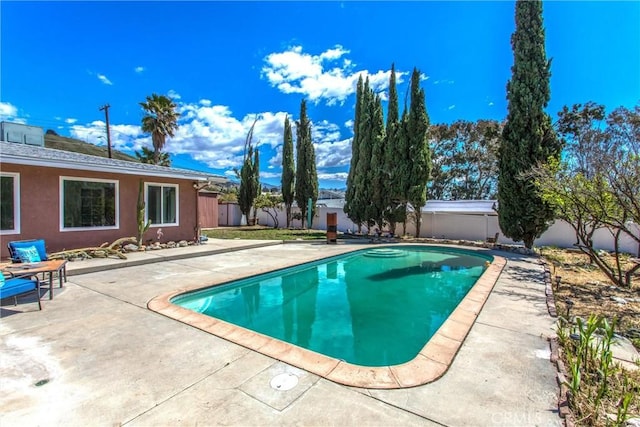 view of pool with a patio, a fenced in pool, and a fenced backyard