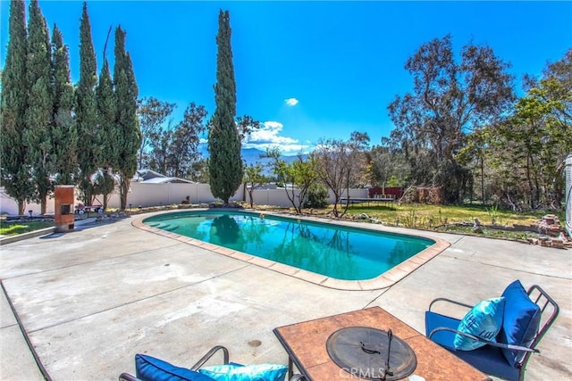 view of pool featuring a fenced in pool, a patio, a fire pit, and a fenced backyard