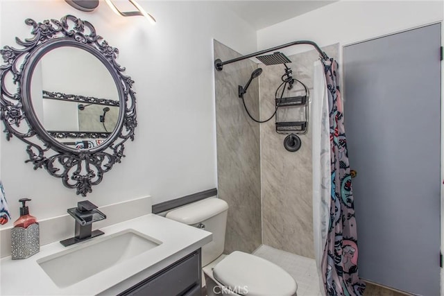 full bathroom featuring toilet, tiled shower, and vanity