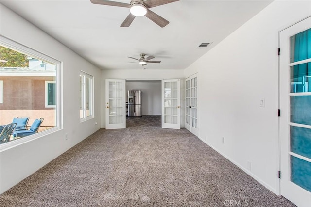 spare room with ceiling fan, french doors, carpet flooring, and visible vents