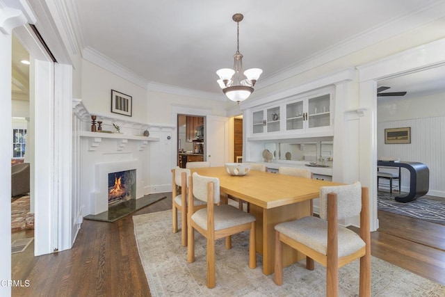 1954 Primrose Ave, South Pasadena, CA 91030 - dining space with wood finished floors, ornamental molding, a lit fireplace, a chandelier, and a decorative wall