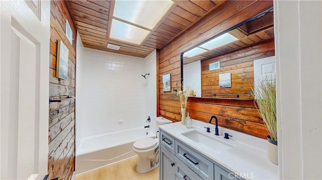 full bath with wooden ceiling, wooden walls, toilet, vanity, and washtub / shower combination
