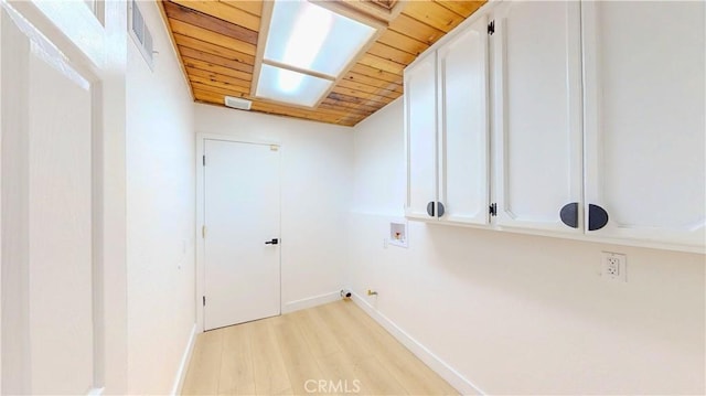 washroom featuring baseboards, wooden ceiling, hookup for a washing machine, light wood-style floors, and cabinet space
