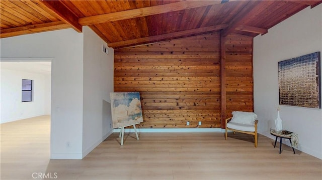 unfurnished room with wooden ceiling, light wood-style floors, and wood walls