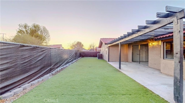 fenced backyard with central air condition unit, a patio area, and a game area