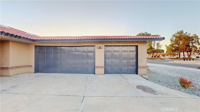 garage featuring concrete driveway