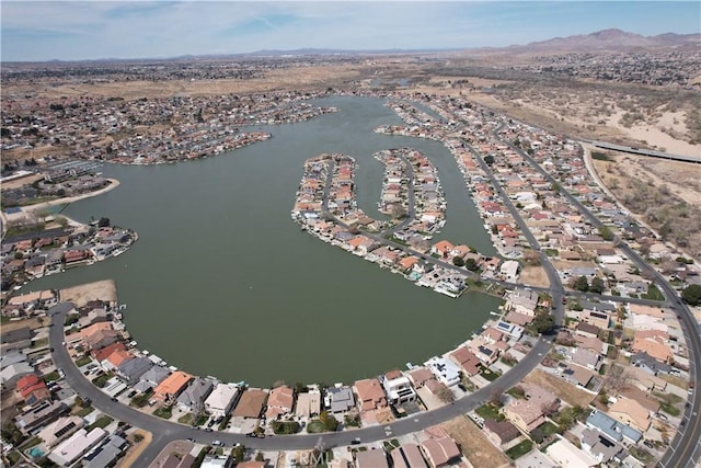 view of property location with a water and mountain view and nearby suburban area