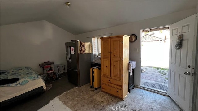 bedroom featuring access to outside, vaulted ceiling, refrigerator with ice dispenser, and light colored carpet