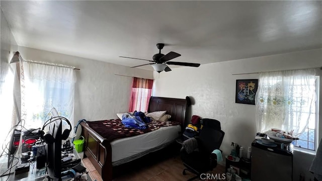bedroom with a textured wall and ceiling fan