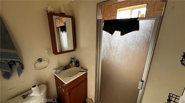 bathroom featuring vanity, toilet, and a shower stall