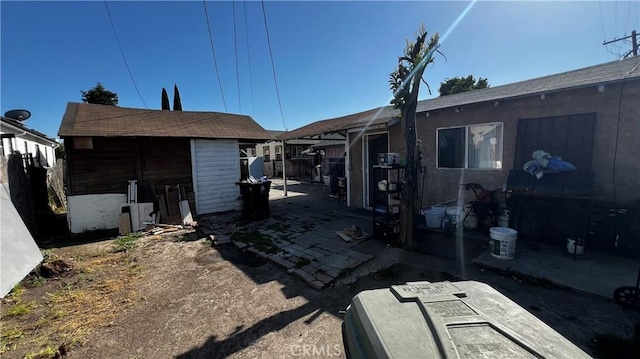 exterior space featuring a patio area and an outbuilding