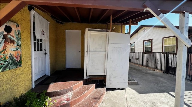 doorway to property featuring stucco siding