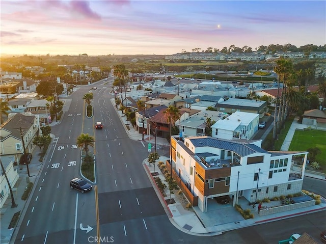 aerial view at dusk featuring a residential view