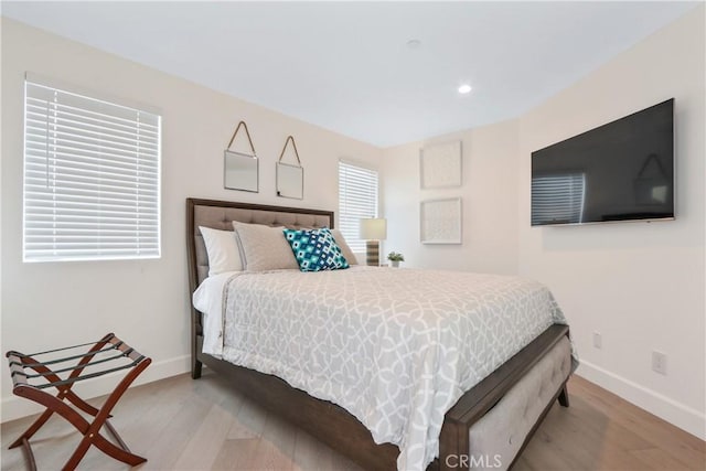 bedroom featuring baseboards, recessed lighting, and wood finished floors