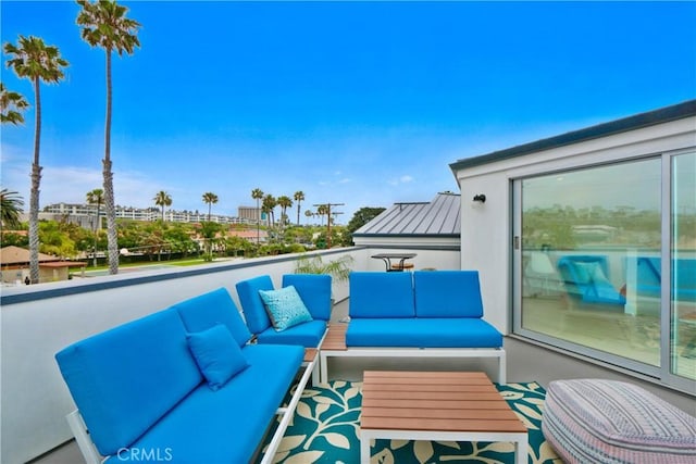 view of patio with outdoor lounge area and a balcony