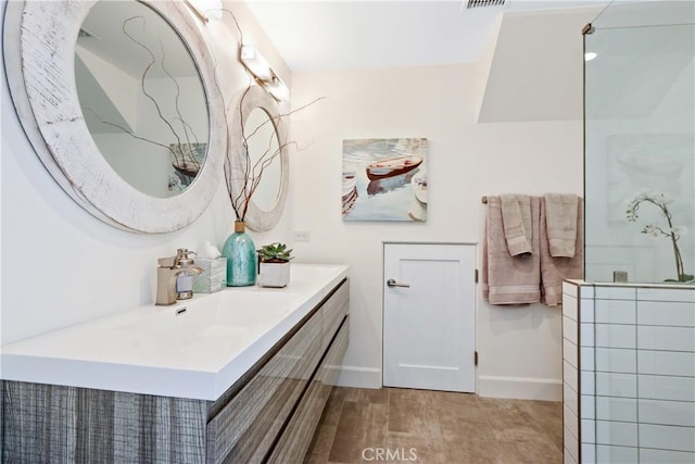 full bath with baseboards, visible vents, and vanity