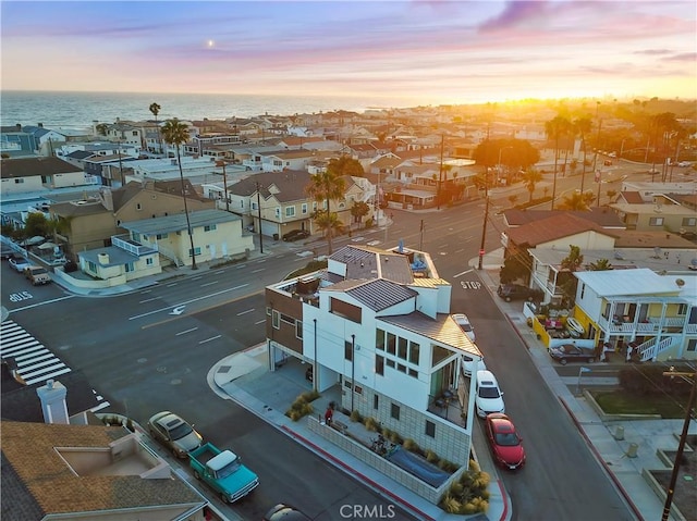 drone / aerial view featuring a residential view and a water view