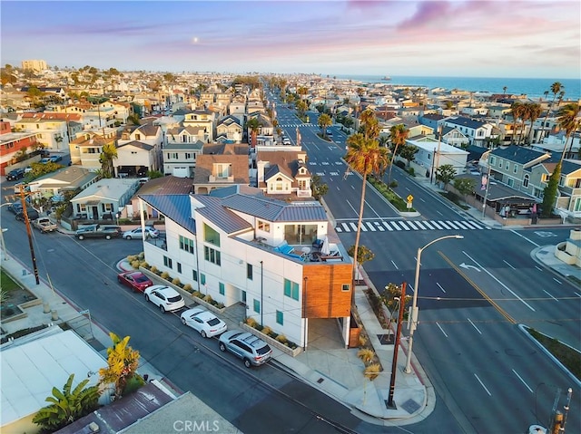aerial view at dusk featuring a residential view