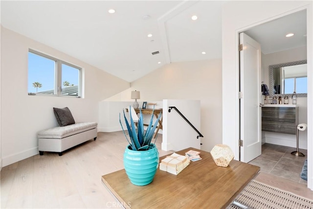 home office featuring light wood finished floors, recessed lighting, baseboards, lofted ceiling, and visible vents