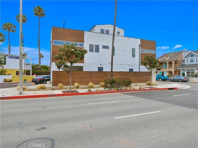 view of building exterior with uncovered parking