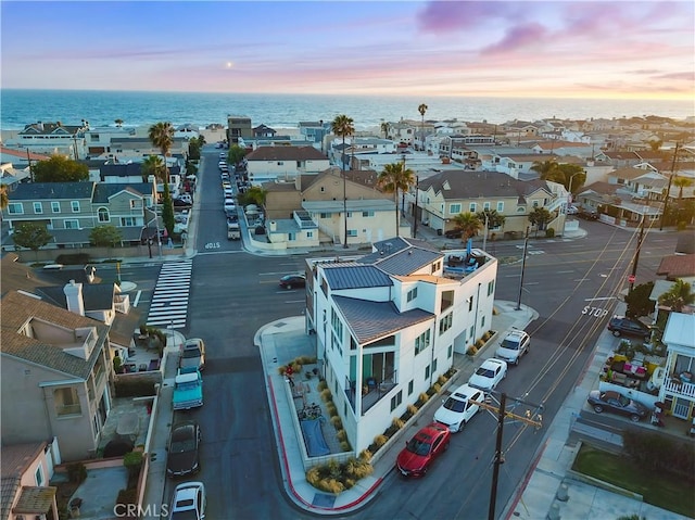 drone / aerial view featuring a water view and a residential view