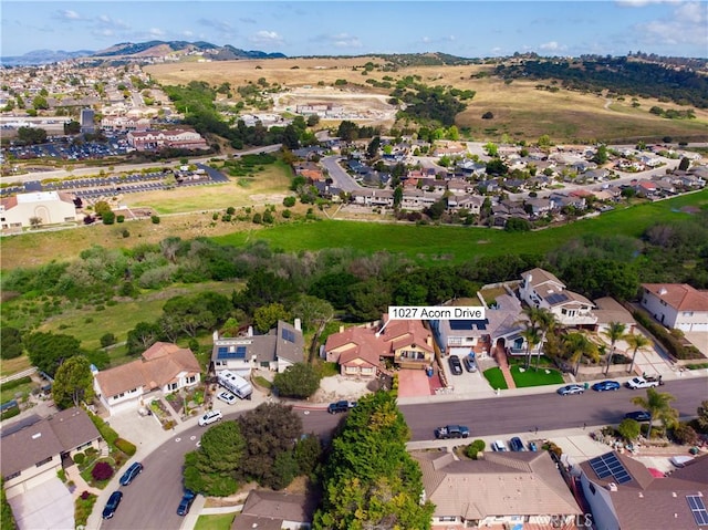 birds eye view of property featuring a mountain view and a residential view