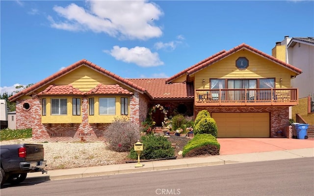 view of front of house with concrete driveway, brick siding, an attached garage, and a tile roof