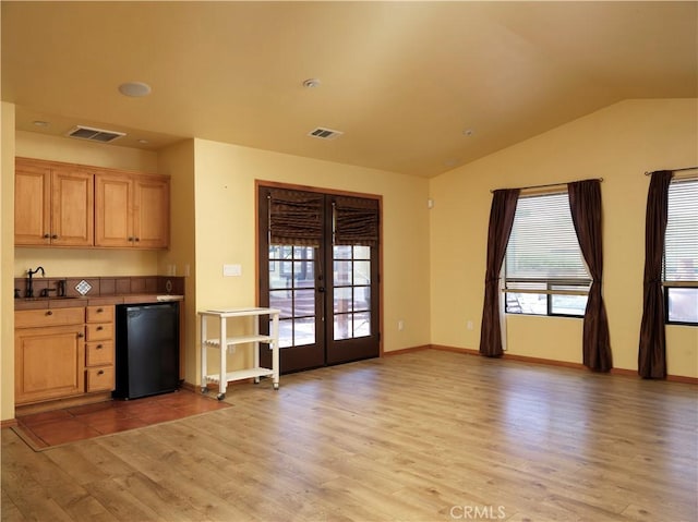 interior space featuring a sink, visible vents, french doors, and light wood-style flooring