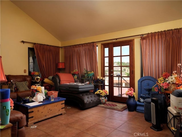 living area with tile patterned floors and high vaulted ceiling
