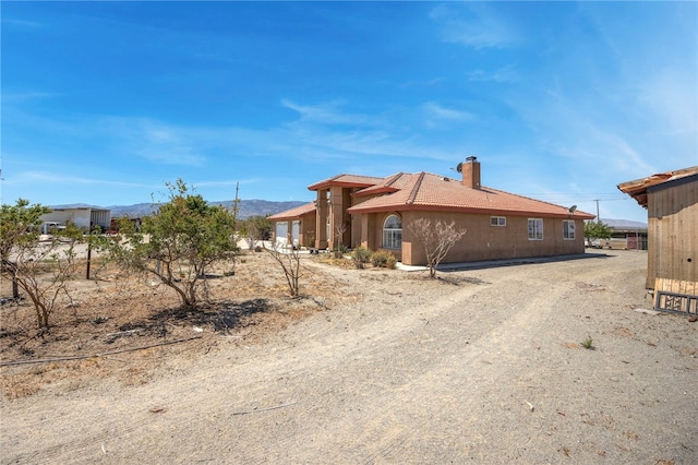 13724 Arena Rd, Pinon Hills, CA 92372 - view of side of home featuring a chimney and a mountain view