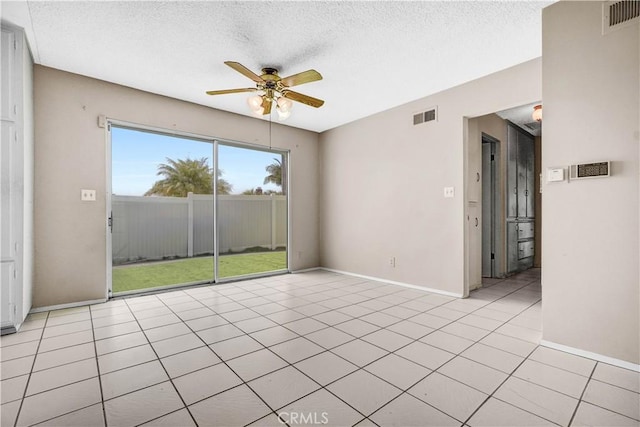 unfurnished room featuring visible vents, a textured ceiling, ceiling fan, and baseboards