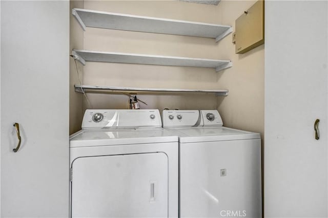 washroom featuring laundry area and washing machine and clothes dryer