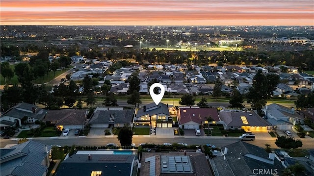 aerial view at dusk featuring a residential view