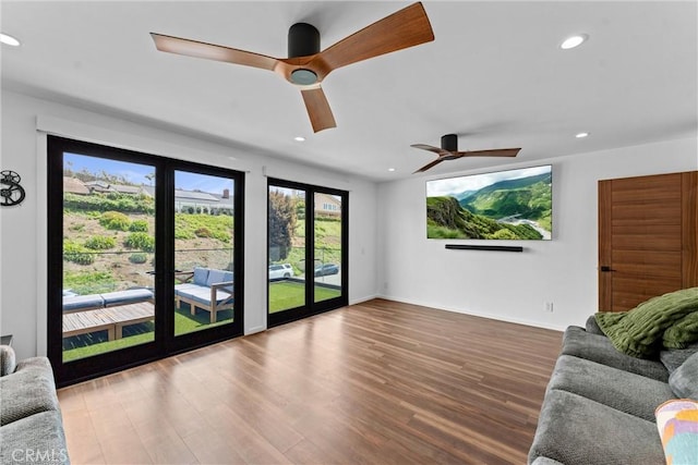 living area featuring recessed lighting, baseboards, ceiling fan, and wood finished floors