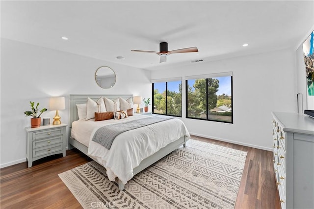 bedroom featuring dark wood-style flooring, ceiling fan, and baseboards