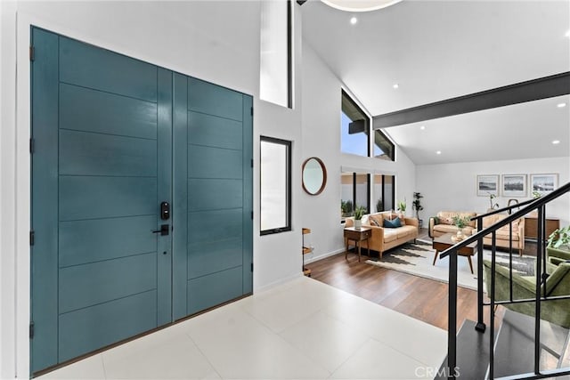 entryway with baseboards and lofted ceiling
