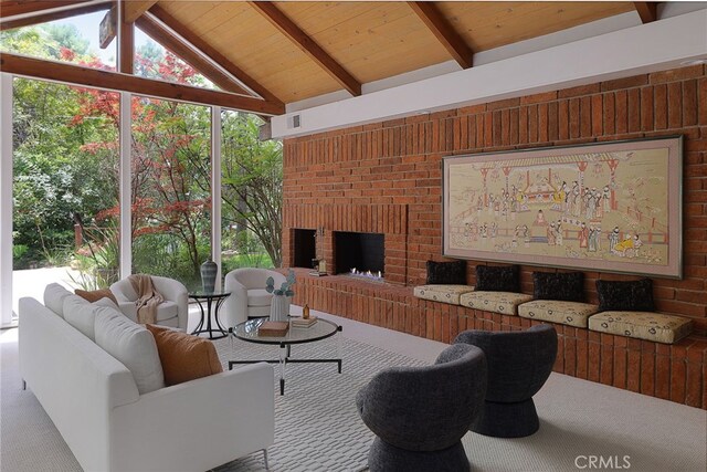 living room featuring wood ceiling, visible vents, a fireplace, carpet floors, and lofted ceiling with beams